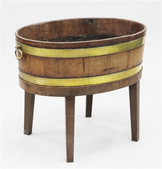 An oval brass bound mahogany open wine cooler on stand, W.2ft 4in.